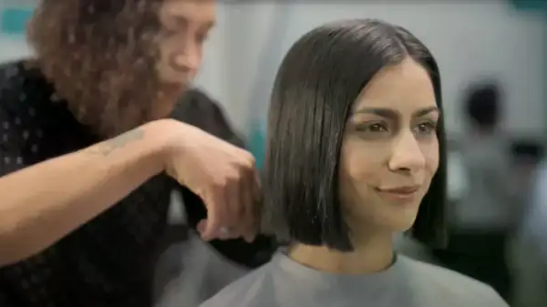 woman getting haircut in great clips salon