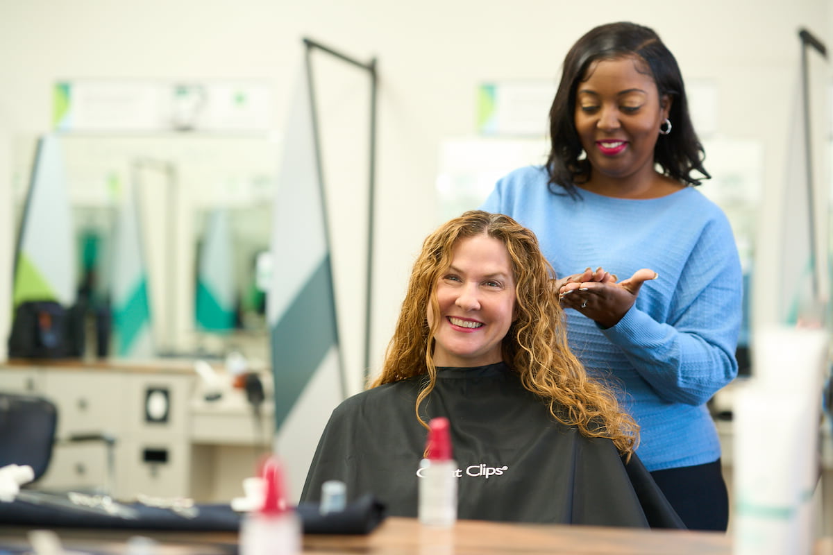A Great Clips stylist putting hair treatment into a woman’s hair. A Great Clips stylist putting hair treatment into a woman’s hair.