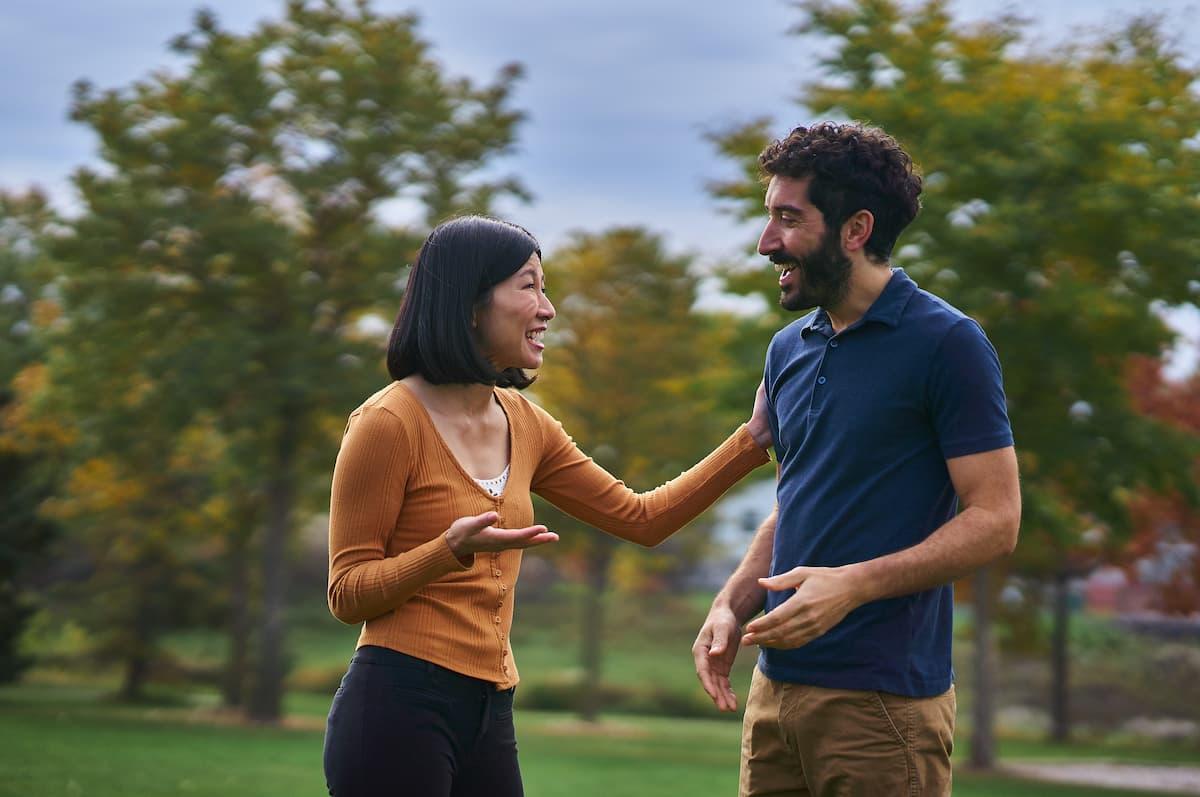 Man and woman laughing together on a beautiful fall day