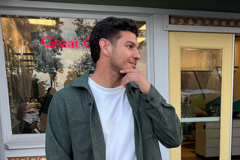 A man with a taper haircut standing outside of a Great Clips salon A man with a taper haircut standing outside of a Great Clips salon